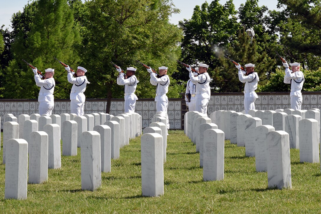 Sailors performing a rifle salute in honor of Melissa Drisko during her interment ceremony at Arlington National Cemetery.