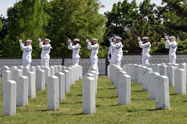 Sailors performing a rifle salute in honor of Melissa Drisko during her interment ceremony at Arlington National Cemetery.