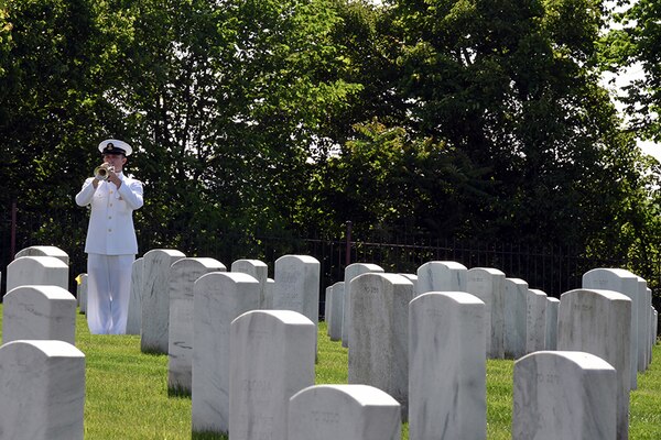 A Navy bugler plays “Taps” at the interment service for former DIA Director Melissa Drisko at Arlington National Cemetery, May 21.