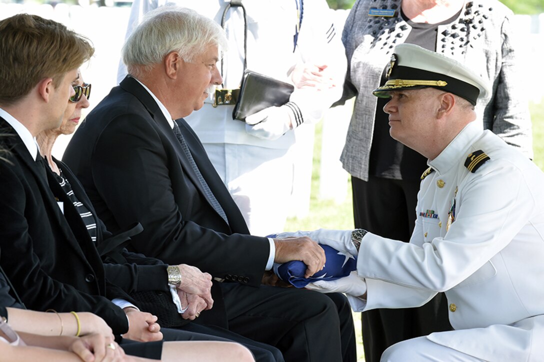 Melissa Drisko’s husband is presented a flag in honor of his late wife during her interment service at Arlington National Cemetery.
