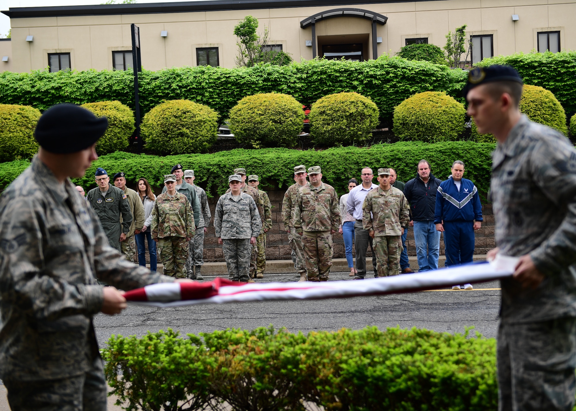 Members of the 911th Airlift Wing watch a flag folding ceremony at the Pittsburgh International Airport Air Reserve Station, Pennsylvania May 13, 2019. Airmen and civilian personnel from all over the base came to participate in the beginning of Law Enforcement Week, which was hosted by the 911th Security Forces Squadron. (U.S. Air Force photo by Senior Airman Grace Thomson)