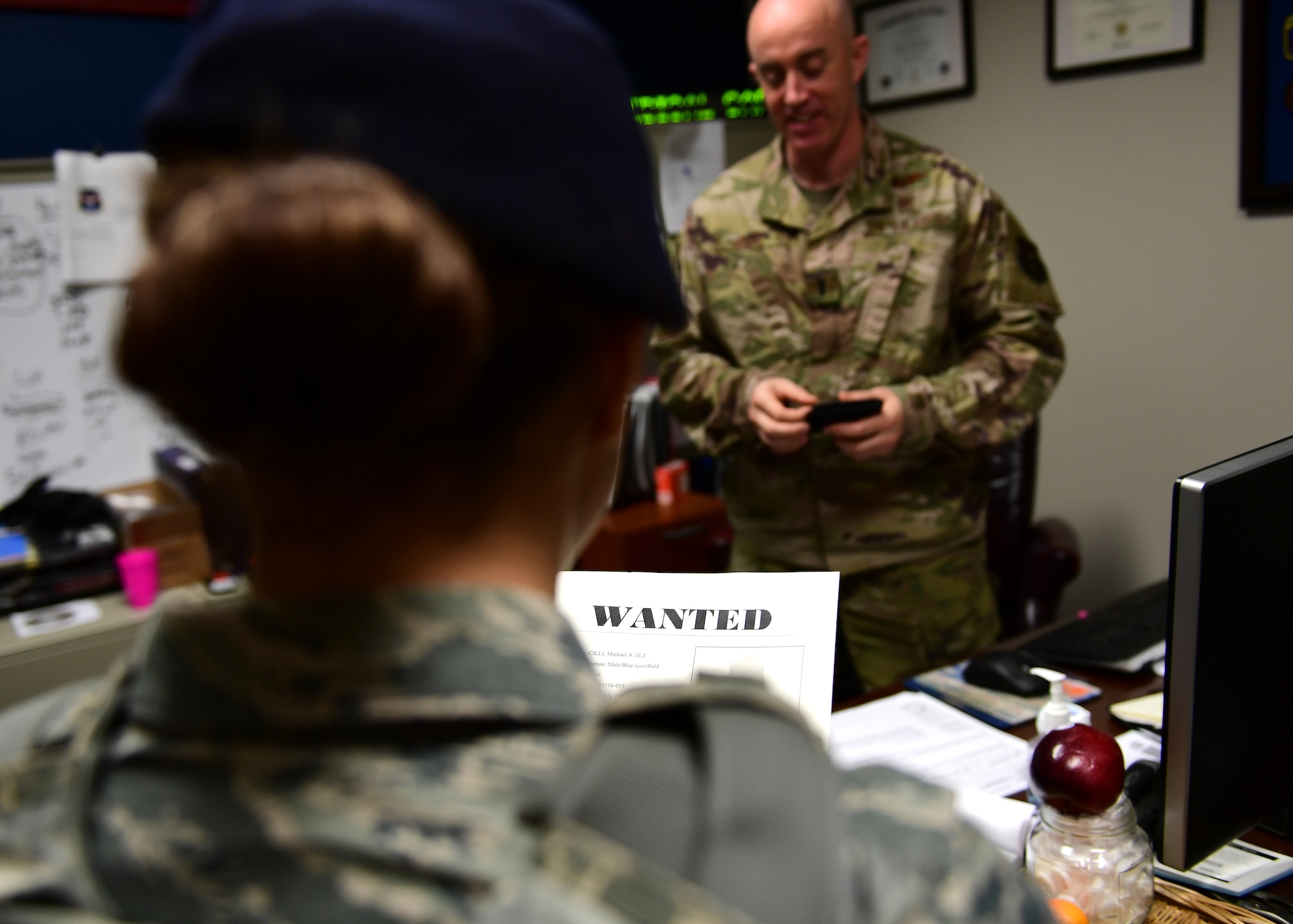 Senior Airman Nicole Dallo, 911th Security Forces member, reads the “arrest warrant” to Lt. Michael Cilli, 911th Aeromedical Staging Squadron health services manager, at the Pittsburgh International Airport Air Reserve Station, Pennsylvania, May 16, 2019. Throughout the day, several 911th SFS members picked up other Airmen around the base for a “jail and bail” fundraiser. (U.S. Air Force photo by Senior Airman Grace Thomson)