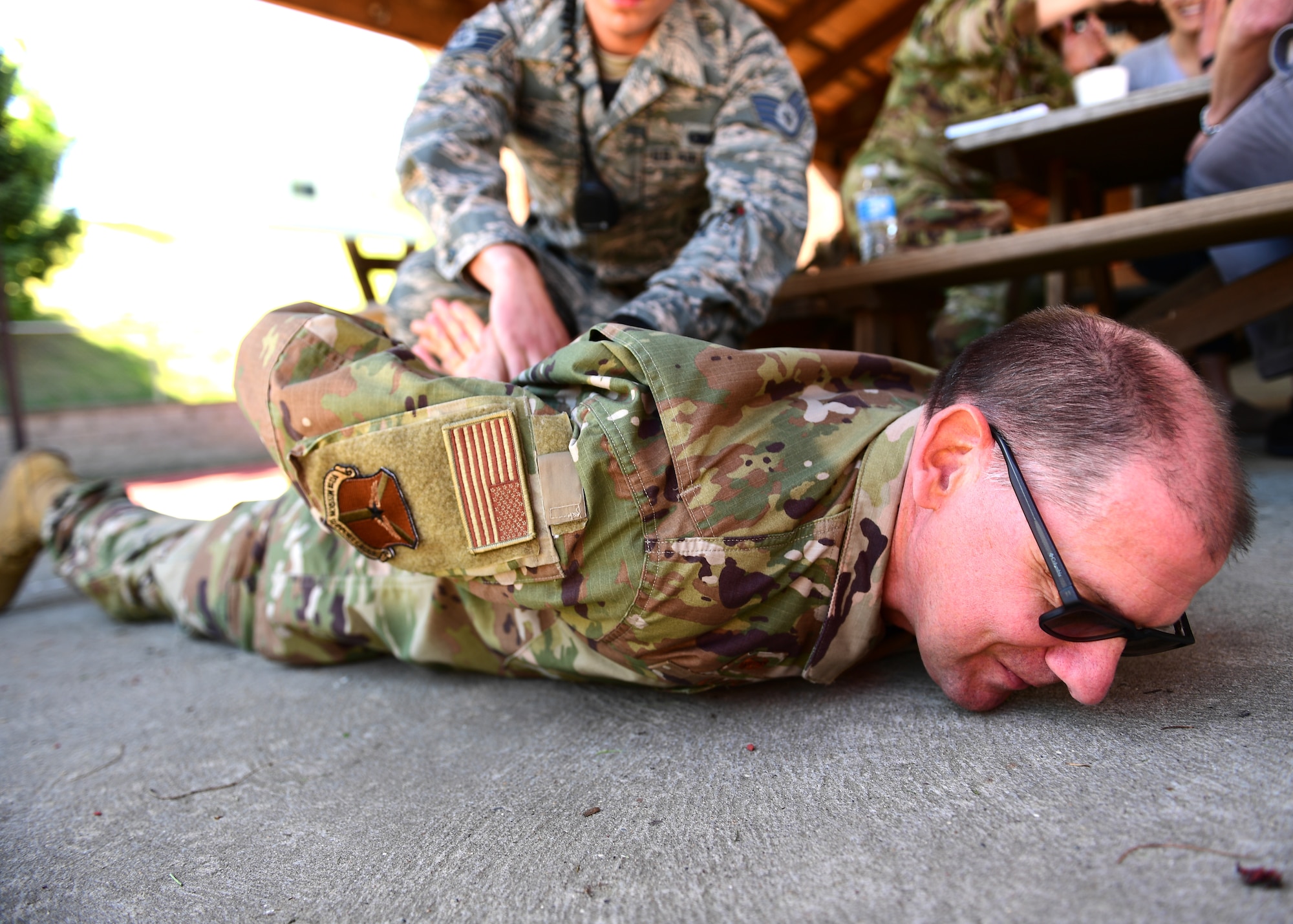 Col. Kenneth Lute, 911th Mission Support Group commander, is put under fake arrest by a member of the 911th Security Forces Squadron at the Pittsburgh International Airport Air Reserve Station, Pennsylvania, May 16, 2019. Lute decided to get on the ground for his arrest even though it was not required for the activity. (U.S. Air Force photo by Senior Airman Grace Thomson)