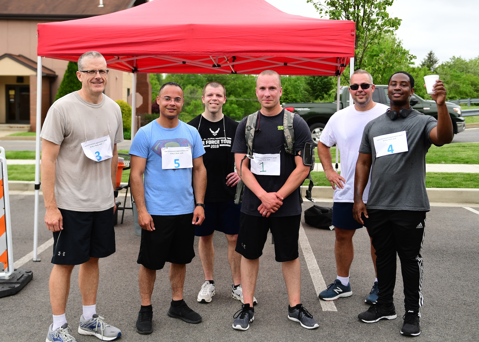 Members assigned to the 911th Airlift Wing pose for a photo after finishing a five-kilometer Ruck, Run, Walk at the Pittsburgh International Airport Air Reserve Station, Pennsylvania, May 17, 2019. The Ruck, Run, Walk was the last of the events for the 911th Security Forces Squadron Law Enforcement Week celebrations. (U.S. Air Force photo by Senior Airman Grace Thomson)