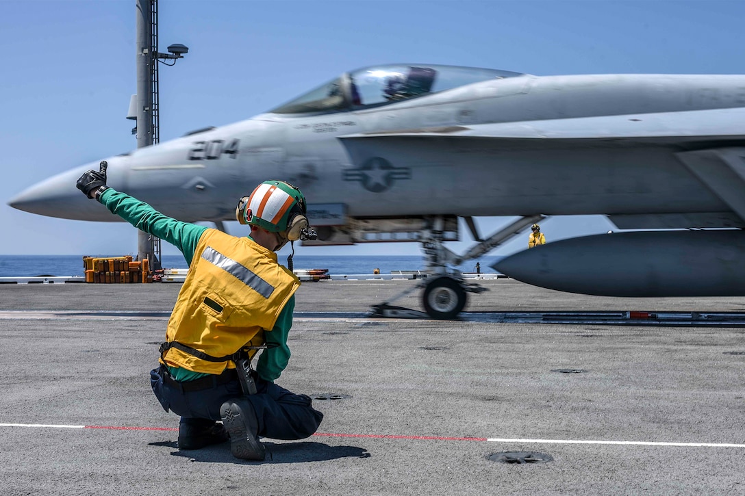 An aircraft prepares to take off from an aircraft carrier.