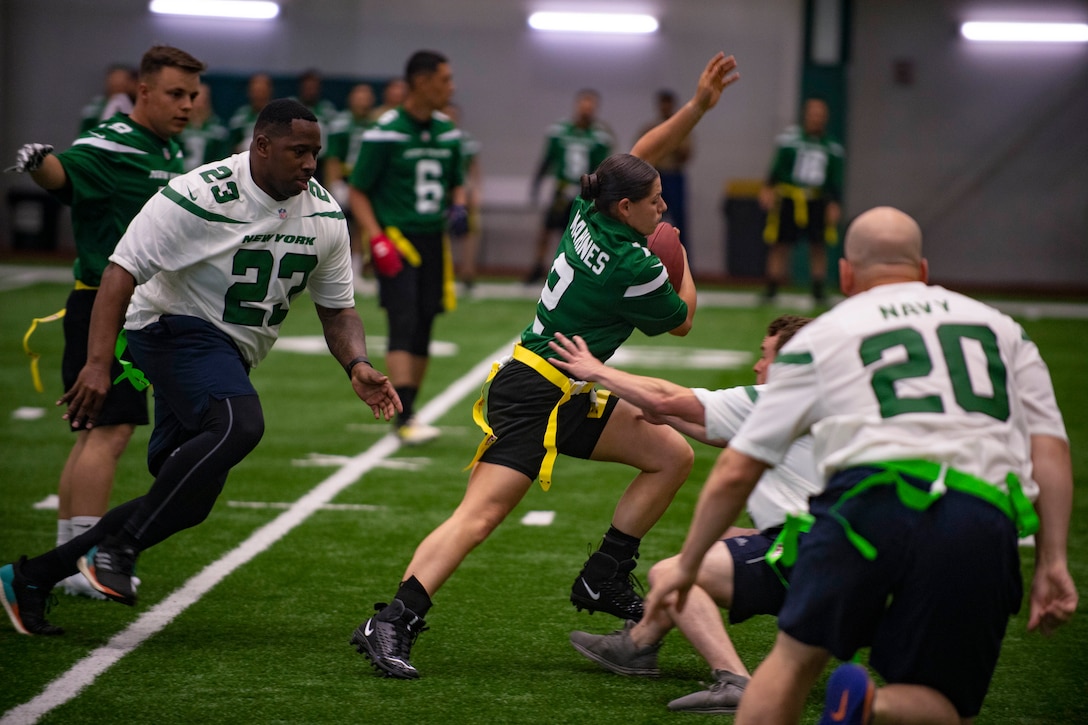 Sailors and Marines play flag football.