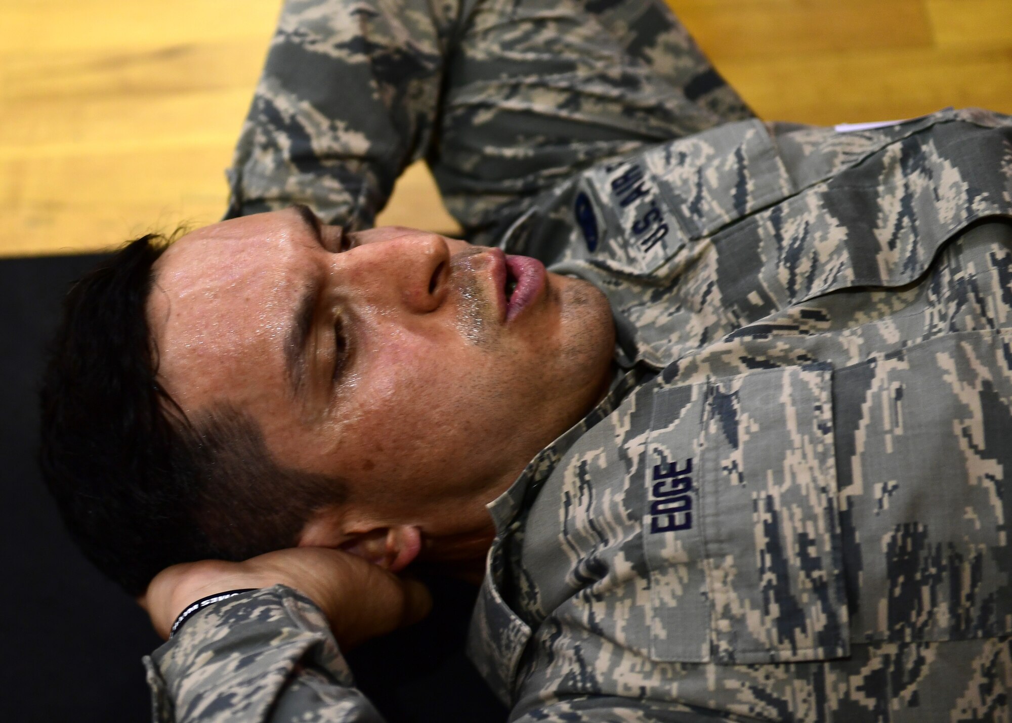 Senior Airman Christopher Edge, 911th Logistics Readiness Squadron supply technician, does the sit-up portion of the U.S. Army physical fitness test at the Pittsburgh International Airport Air Reserve Station, Pennsylvania, May 4, 2019. In order to qualify for the Combat Air Assault training, candidates must pass a U.S. Army physical fitness test 30 days before the school starts to ensure they have the strength and endurance needed to complete the course. (U.S. Air Force photo by Senior Airman Grace Thomson)