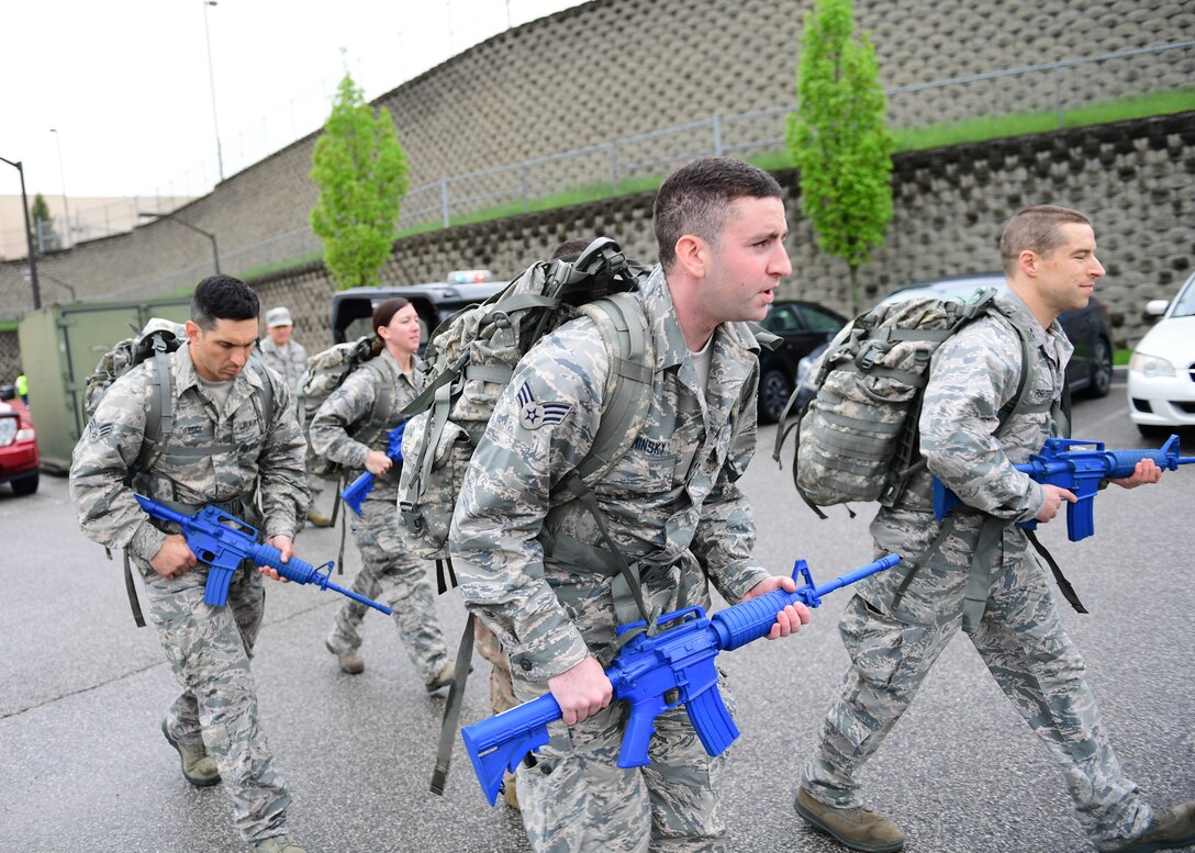 Airmen assigned to the 911th Airlift Wing, begin a six-mile ruck march at the Pittsburgh International Airport Air Reserve Station, Pennsylvania, May 5, 2019. A ruck march is when Airmen carry a backpack full of weights and walk at a vigorous pace over a predetermined course to build up their physical and mental endurance. (U.S. Air Force photo by Senior Airman Grace Thomson)