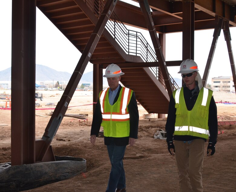 Dr. McCallister (left) and Michael Mills, civil engineer at the District's Kirtland AFB Resident Office, walk through the first floor of the NNSA Albuquerque Complex building, March 21, 2019.