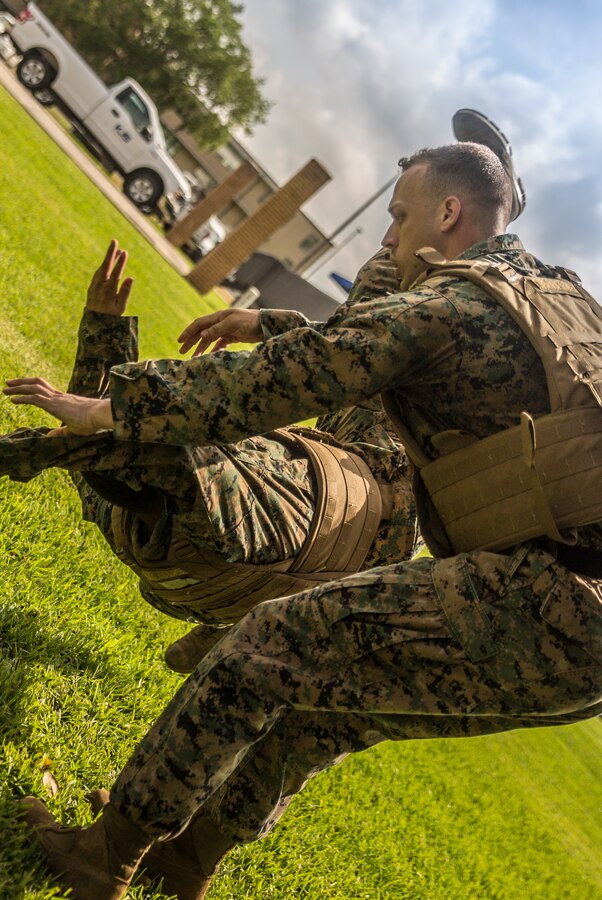 U.S. Marine Corps Staff Sgt. Zachary Hilko, right, an aviation supply chief, executes a hip throw on Cpl. Luis Alicea, left, a ground support equipment mechanic, both with Marine Aircraft Group 49, 4th Marine Aircraft Wing, Marine Forces Reserve, during Martial Arts Instructor Course 1-19 at Naval Air Station Joint Reserve Base New Orleans on May 22, 2019. Marines execute a hip throw to take the opponent to the ground while remaining in a standing position. To increase readiness and to support the total force, Reserve and active Marines with MARFORRES participate in the MAI Course. (U.S. Marine Corps photo by Lance Cpl. Preston L. Morris)