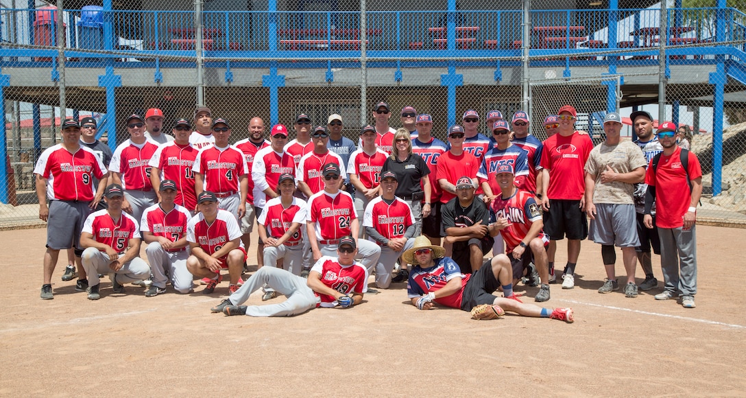 Members of the MCLB Barstow Marines, NTC Ft. Irwin Soldiers, and MCLB Fire Department teams, take time to pose for a photo together after the Armed Forces Softball Tournament held at the Robert A. Sessions Sportspark in Barstow, May 18.