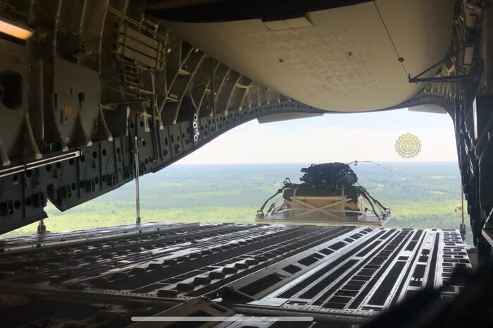 A pallet of cargo is air-dropped out the back out of a Charleston-based C-17 Globemaster III during the Palmetto Challenge Exercise May 23 near Pope Field, North Carolina.