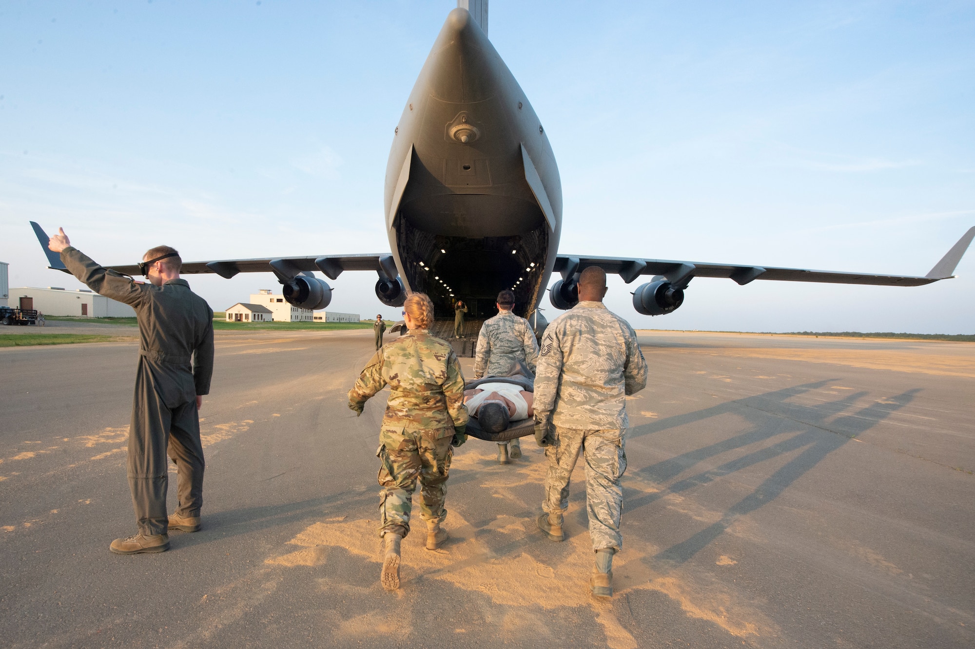 315th Aeromedical Evacuation Squadron ground crew members carry a simulated patient on a litter to board a Charleston-based C-17 Globemaster III during the Palmetto Challenge Exercise May 22 near Pope Field, North Carolina.