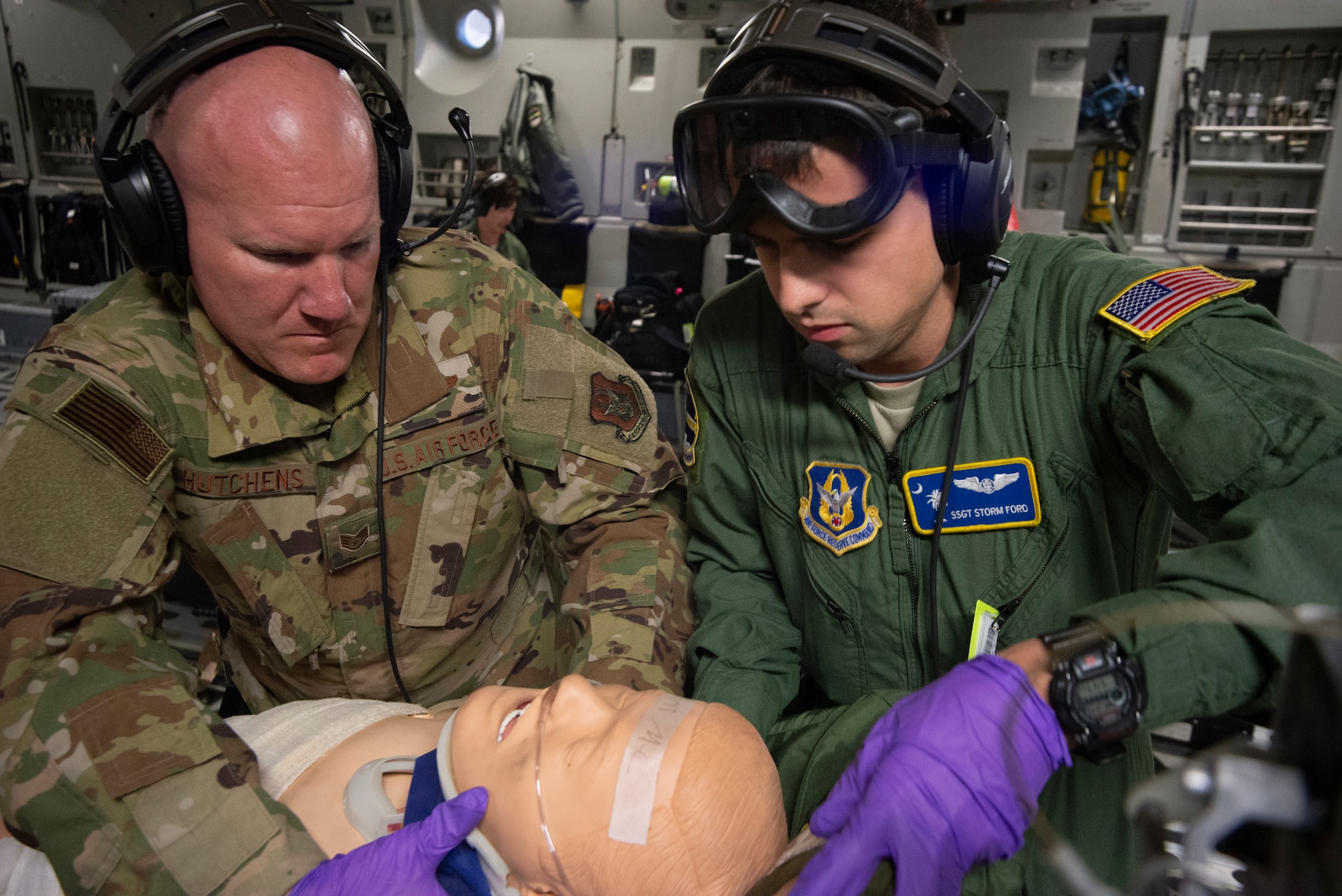 Staff Sergeants Aaron Hutchens and Storm Ford, 315th Aeromedical Evacuation Squadron, treat a simulated patient aboard a Charleston-based C-17 Globemaster III during the Palmetto Challenge Exercise May 22 near Pope Field, North Carolina.