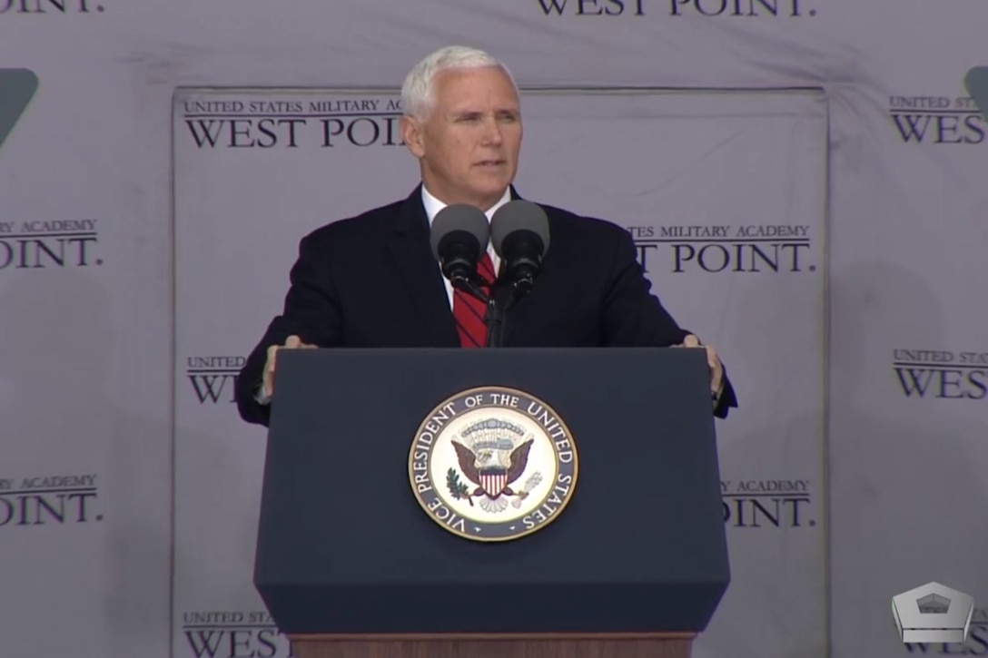 A man speaks at a podium.