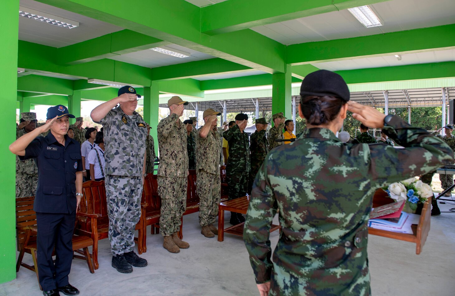 190525-N-RM689-1007

CHON BURI PROVINCE, Thailand (May 25, 2019) - Pacific Partnership 2019 leaders salute during the playing of the U.S. and Thai national anthems at the ribbon cutting ceremony that marks the completion of the new restroom facility at the Ban Mabfugthong School project site during Pacific Partnership 2019. The scope of the project included construction of a four-stall restroom, which will provide additional facilities for students to use during school and for local community gatherings held at the facility. Pacific Partnership, now in its 14th iteration, is the largest annual multinational humanitarian assistance and disaster preparedness mission conducted in the Indo-Pacific. Each year, the mission team works collectively with host and partner nations to enhance regional interoperability and disaster response capabilities, increase stability and security in the region, and foster new and enduring friendships across the Indo-Pacific.