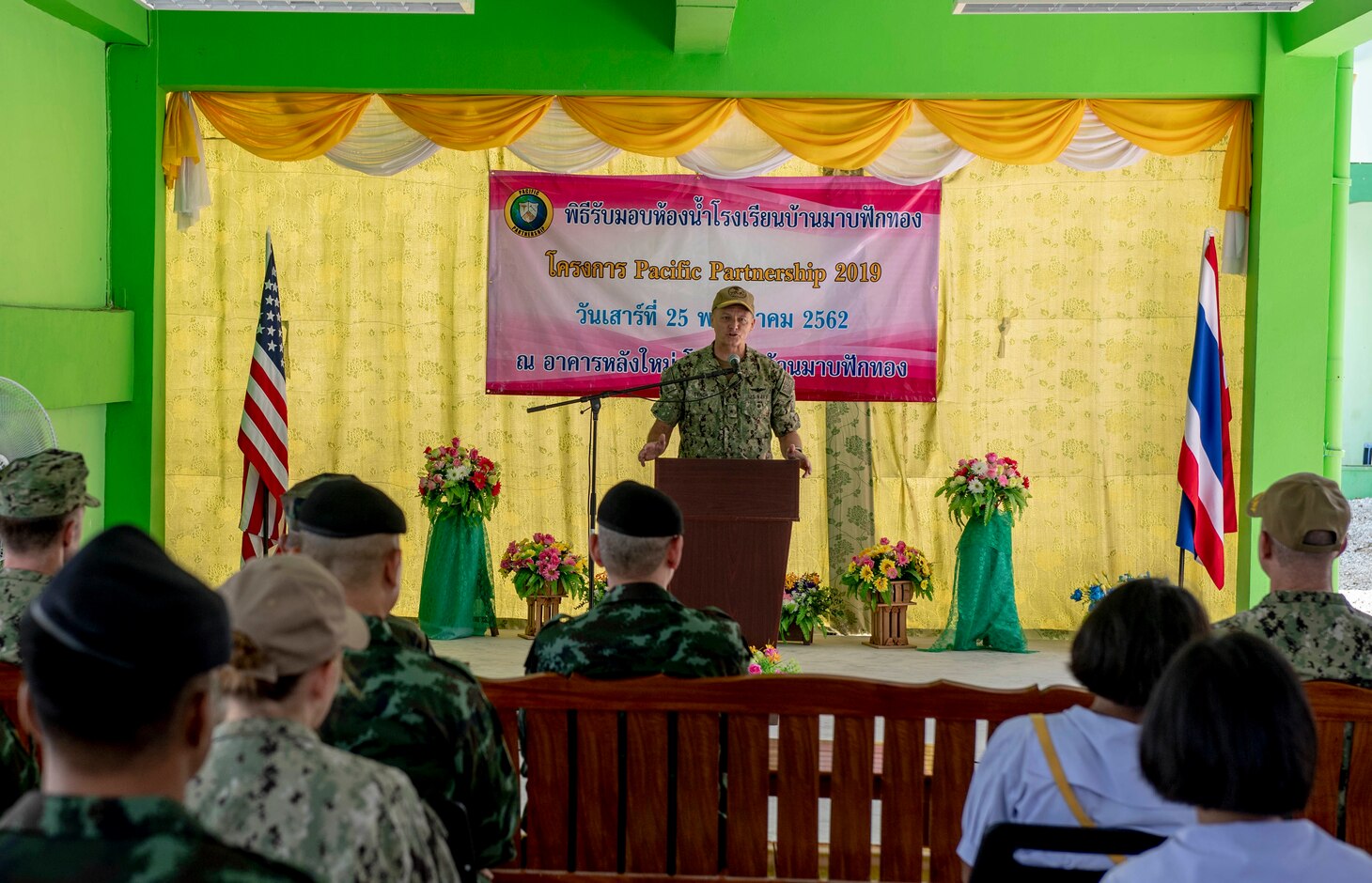 190525-N-RM689-1023

CHON BURI PROVINCE, Thailand (May 25, 2019) - Rear Adm. Joey Tynch III, commander, Task Force 73, speaks at a ribbon cutting ceremony that marks the completion of the new restroom facility at the Ban Mabfugthong School during Pacific Partnership 2019. The scope of the project included construction of a four-stall restroom, which will provide additional facilities for students to use during school and for local community gatherings held at the facility. Pacific Partnership, now in its 14th iteration, is the largest annual multinational humanitarian assistance and disaster preparedness mission conducted in the Indo-Pacific. Each year, the mission team works collectively with host and partner nations to enhance regional interoperability and disaster response capabilities, increase stability and security in the region, and foster new and enduring friendships across the Indo-Pacific.