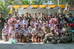 CHON BURI PROVINCE, Thailand (May 25, 2019) Pacific Partnership 2019 leaders, U.S. Navy Sailors assigned to Amphibious Construction Battalion (ACB) 1, members of the Royal Thai Armed Forces and children who attend the Ban Mabfugthong School pose for a photo during the ribbon cutting ceremony that marks the completion of the new restroom facility at the school during Pacific Partnership 2019. The scope of the project included construction of a four-stall restroom, which will provide additional facilities for students to use during school and for local community gatherings held at the facility. Pacific Partnership, now in its 14th iteration, is the largest annual multinational humanitarian assistance and disaster preparedness mission conducted in the Indo-Pacific. Each year, the mission team works collectively with host and partner nations to enhance regional interoperability and disaster response capabilities, increase stability and security in the region, and foster new and enduring friendships across the Indo-Pacific.