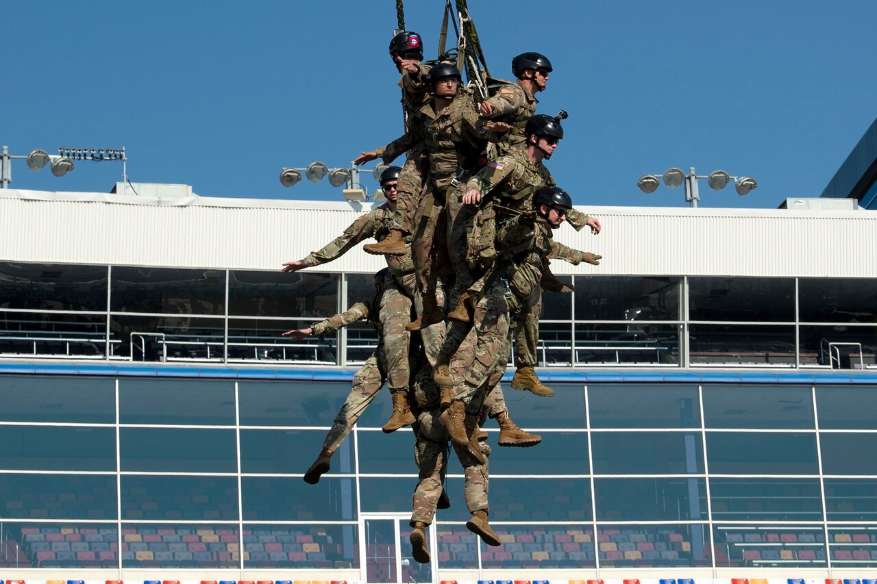 Soldiers are airlifted off a racetrack.