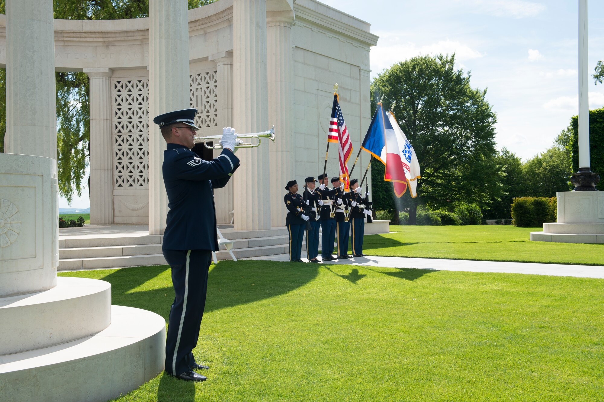 U.S. Air Force Staff Sgt. Nicholas Del Villano, U.S. Air Forces in Europe Jazz Band trumpeter, play taps on a bugle during a Memorial Day ceremony at the Saint-Mihiel American Cemetery, Thiaucourt-Regniéville, France, May 26, 2019. The ceremony at Saint-Mihiel American Cemetery recognized both the Americans and the French service members who perished in combat. (U.S. Air Force photo by Staff Sgt. Jonathan Bass)