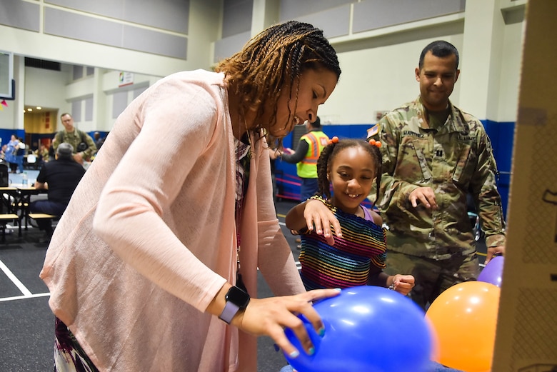 Jaime Narin, a fifth grade teacher, and her daughter Jaichelle Narin, a second grade student, and Capt. Rodolfo Martinez, a U.S. Army Corps of Engineers, Far East District project engineer, participate in an interactive activity during a Science, Technology, Engineering, and Math (STEM) event held at Humphreys Central Elementary School, Camp Humphreys, South Korea, May 23.