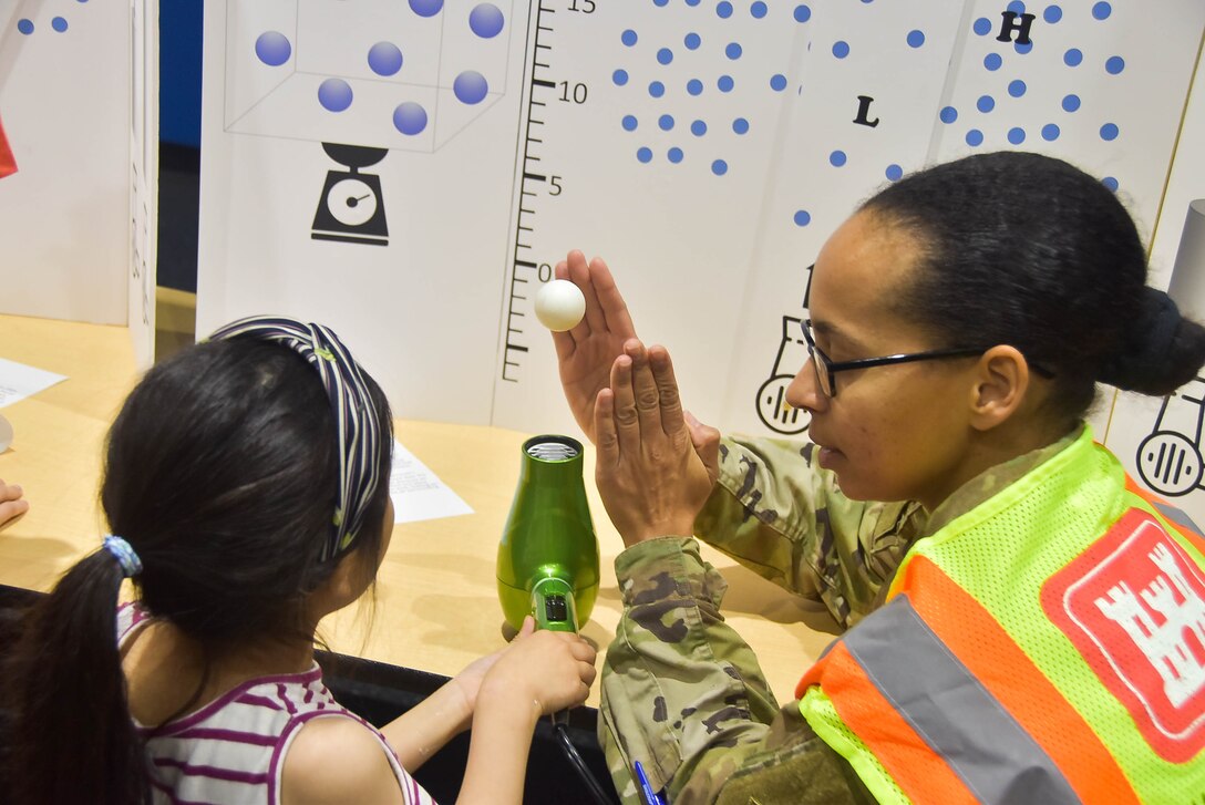 Capt. Heathra King, a U.S. Army Corps of Engineers, Far East District operations officer, interacts with a student during a Science, Technology, Engineering, and Math (STEM) event held at Humphreys Central Elementary School, Camp Humphreys, South Korea, May 23.