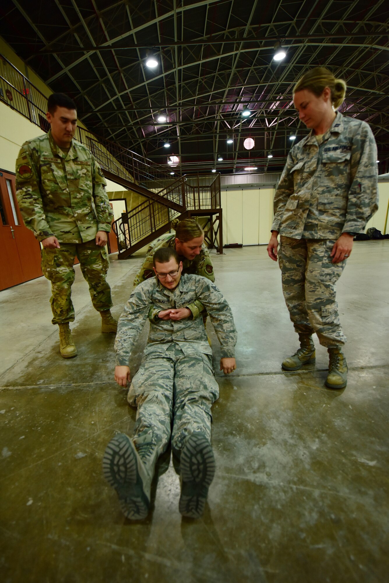 Staff Sgt. Haillie Luebke, Self-Aid Buddy Care advisor, trains Airmen on fore-and-aft carries during Ability to Survive and Operate training May 24, 2019, at Incirlik Air Base, Turkey. The fore-and-aft carry can be used to transport conscious or unconscious casualties to safety. (U.S. Air Force photo by Tech. Sgt. Jim Araos)