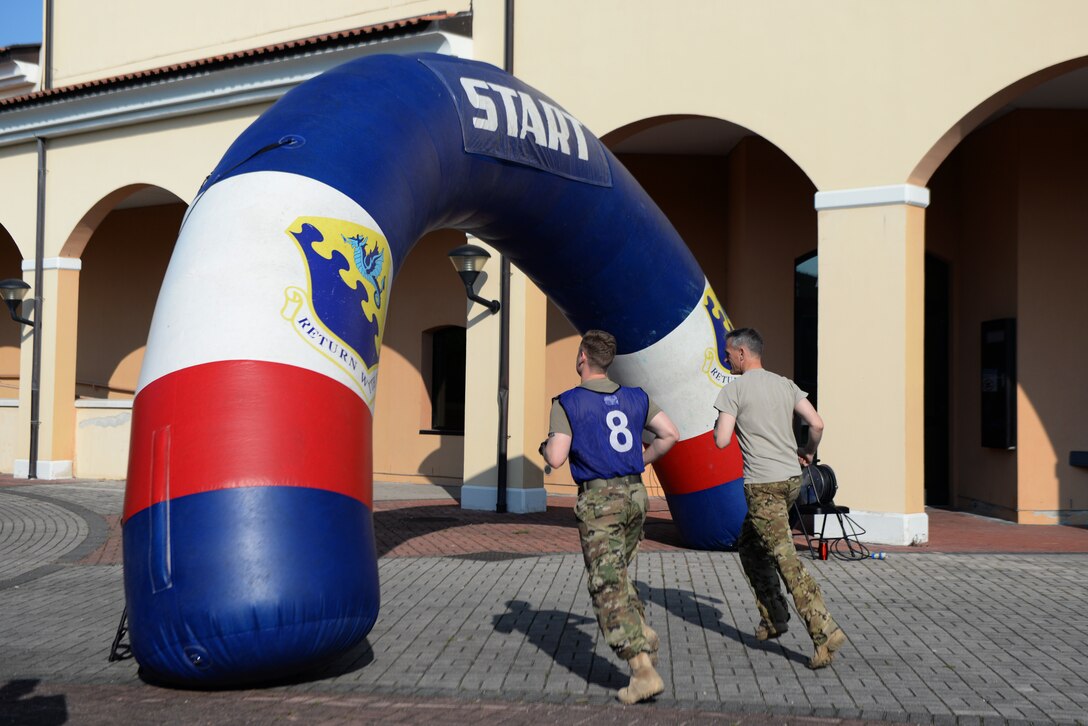 U.S. Air Force Brig. Gen. Daniel T. Lasica, 31st Fighter Wing commander and U.S. Air Force Maj. Alexander Prevendar, 31st Fighter Wing director of staff, start at the beginning of an eight obstacle course prepared by the 31st Medical Group during the Wing Warrior Challenge at Aviano Air Base, Italy, May 24, 2019. The 31st MDG supports the readiness of 31st FW and associated units throughout the Southern Region, ensuring the health of its community by providing optimal patient-focused medical care from internal, Department of Defense and Host Nation resources. (U.S. Air Force photo by Airman 1st Class Ericka A. Dechane).