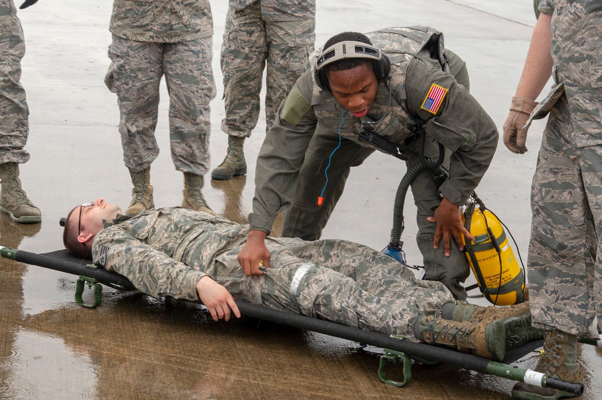 U.S. Air Force Staff Sgt. Marquis Waters, an aeromedical evacuation technician with the 514th Aeromedical Evacuation Squadron, 514th Air Mobility Wing, checks a patient for potential threats before bringing him on a C-130 Hercules from the 53rd Weather Reconnaissance Squadron, Keesler Air Force Base at Stennis International Airport, Kiln, Miss., May 19, 2019. This was part of a Predeployment Dissimilar Aircraft Readiness Training held at the airport. (U.S. Air Force photo by 1st Lt. Emily Rautenberg)