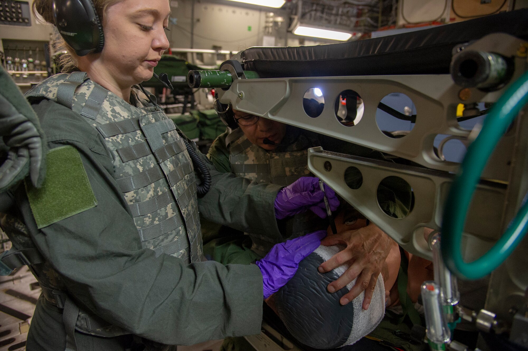 U.S. Air Force Senior Airman Kristen Warbrick, an aeromedical evacuation technician with the 514th Aeromedical Evacuation Squadron, 514th Air Mobility Wing, holds the head of a medical mannequin with an eye injury on a C-17 Globemaster III crewed by Reserve Citizen Airmen with the 732nd Airlift Squadron, also with the 514th, at Stennis International Airport, Kiln, Miss., May 18, 2019. The 514th is an Air Force Reserve Command unit. (U.S. Air Force photo by 1st Lt. Emily Rautenberg)