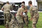 Oklahoma Army National Guard Soldiers from Company B, 1st Battalion, 279th Infantry Regiment, stack sandbags in order to slow the spread of flood waters in Sandy Parks, Oklahoma. Oklahoma Army National Guard Soldiers assisted several Oklahoma communities following record rain fall and numerous tornados. The Guard members' assistance included swift water rescue, filling and distributing sandbags and delivering purified, potable water.