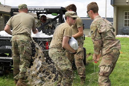 Oklahoma Army National Guard Soldiers from Company B, 1st Battalion, 279th Infantry Regiment, stack sandbags in order to slow the spread of flood waters in Sandy Parks, Oklahoma. Oklahoma Army National Guard Soldiers assisted several Oklahoma communities following record rain fall and numerous tornados. The Guard members' assistance included swift water rescue, filling and distributing sandbags and delivering purified, potable water.