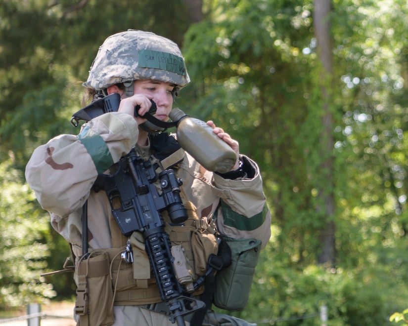 Senior Airman Savannah Leslie, an installation entry controller assigned to the 628 Security Forces Squadron, drinks from her canteen during exercise Palmetto Challenge May 21, 2019, at Joint National Guard Base McEntire, S.C.