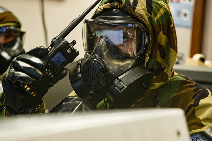Staff Sgt. Lopaz Curry, an emergency operations center representative assigned to the 628th Air Base Wing, speaks into a mobile radio while in mission oriented protective posture (MOPP) gear during exercise Palmetto Challenge May 22, 2019, at McEntire Air National Guard Base, S.C.