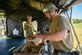 Tech. Sgt. Jonathan Ardis, 628th Force Support Squadron readiness NCOIC, prepares a plate for Col. Bobby Degregorio, 315th Mission Support Group commander within the Single Pallet Expeditionary Kitchen, during exercise Palmetto Challenge, May 21, 2019, at Joint National Guard Base McEntire, S.C.