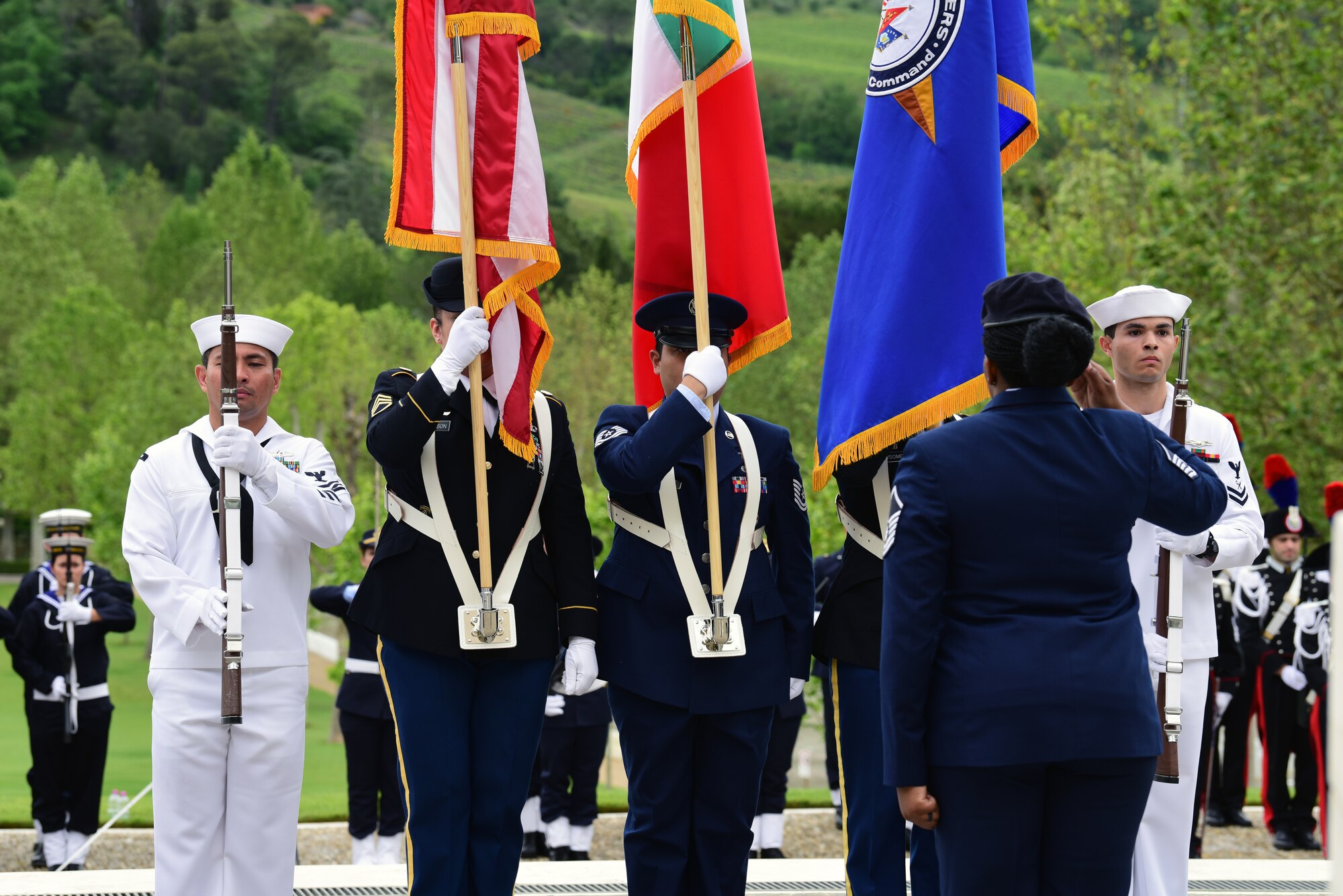 Master Sgt. Tamieka Morgan, 31st Fighter Wing executive assistant to the command chief, salutes as a joint service color guard presents the colors at the Florence American Cemetery Memorial Day event in Florence, Italy on May 27, 2019. The 31st Fighter Wing represented the U.S. Air Force by sending a formation of Airmen. (U.S. Air Force photo by Airman 1st Class Caleb House)