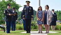 Lt. Gen. James H. Dickinson, commanding general, U.S. Army Space and Missile Defense Command/Army Forces Strategic Command, and members of the command honor Tiffany and Kylee Little, wife and daughter of Spc. Kyle Little, during the raising of a Gold Star Service Flag in recognition of Gold Star Families for Memorial Day Weekend. More than 50 Gold Star Family Members were present during raising of a Gold Star Flag with the American flag during a ceremony at the command’s Redstone Arsenal, Alabama, headquarters May 24. (U.S. Army photo by Ronald Bailey)