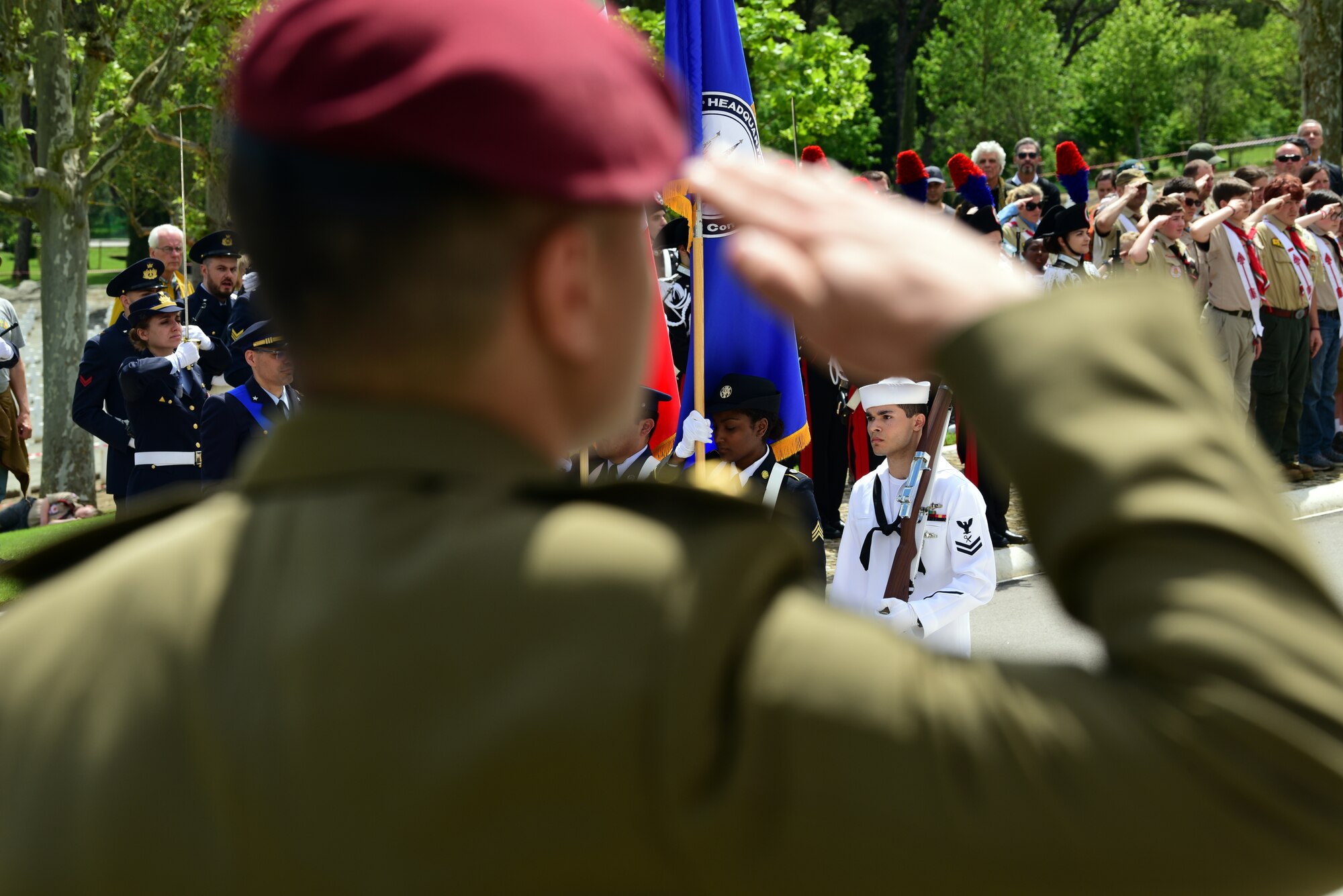 A joint service color guard marches away from the ceremony at the Florence American Cemetery Memorial Day event in Florence, Italy on May 27, 2019. The color guard carried the flags of the United States, Italy and the U. S. European Command Headquarters. (U.S. Air Force photo by Airman 1st Class Caleb House)