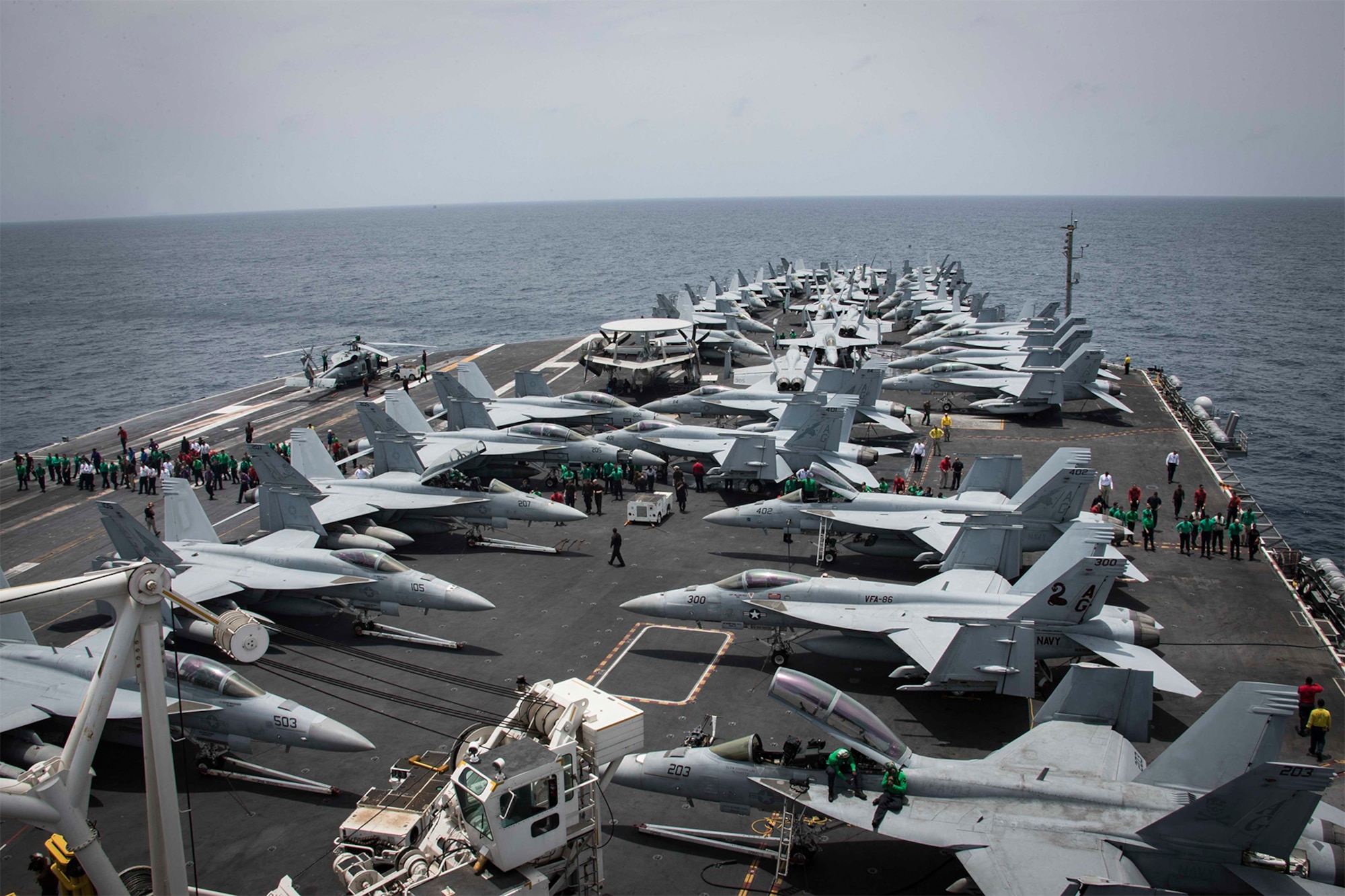 Sailors partake in a foreign object and debris walk-down on the flight deck of the Nimitz-class aircraft carrier USS Abraham Lincoln in the Arabian Sea, May 10, 2019. Abraham Lincoln Carrier Strike Group 12 is deployed to the U.S. 5th Fleet area of operations.