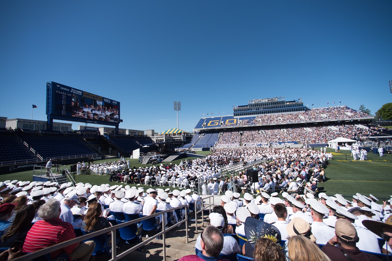 A large crowd is gathered at a football stadium.