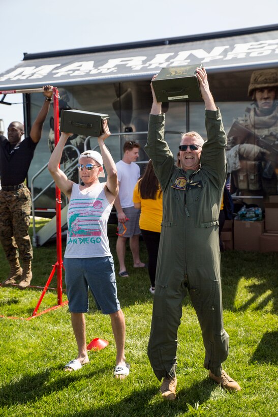 U.S. Marine Corps Col. Robert J. Goetz, a recruiting support officer with Headquarters 1st Marine Corps District, completes a set of ammo can lifts with a New York native during a Fleet Week New York (FWNY) Jones Beach air show, at Jones Beach in Wantagh, N.Y., May 25, 2019. FWNY is an opportunity for the citizens of New York City and the surrounding tristate area to come together with the nation’s sea services through community engagement to gain a better understanding of how the sea services support the national defense of the United States. (U.S. Marine Corps photo by Cpl. Tojyea G. Matally)