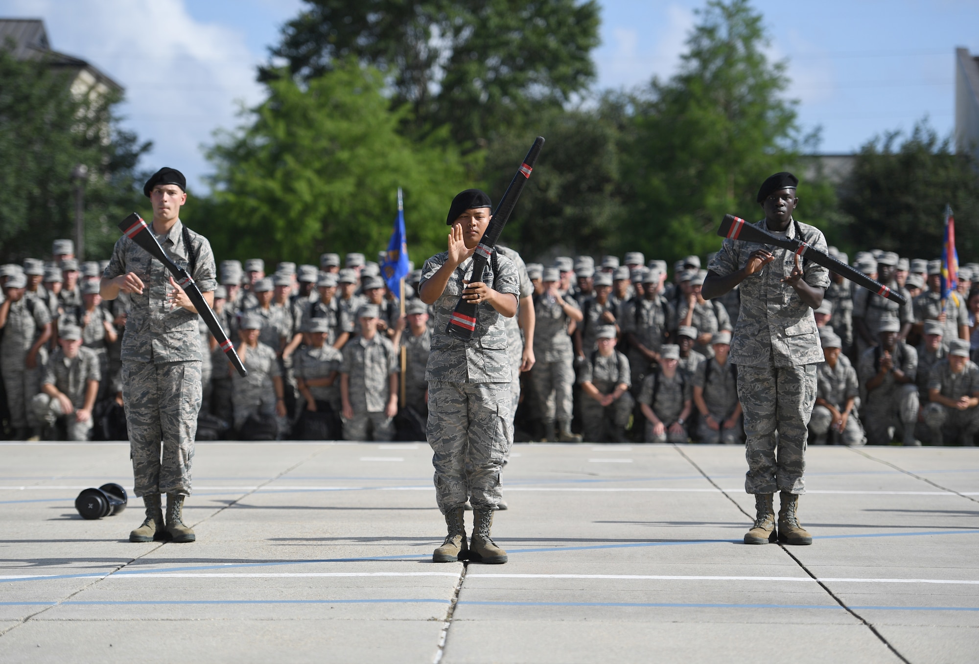 The Keesler Air Force Base freestyle drill team performs their routine at the Levitow Training Support Facility drill pad on Keesler Air Force Base, Mississippi, May 21, 2019. The drill teams, made up of Airmen from various squadrons within the 81st Training Group, debuted their performances in front of base leadership and their peers. Every year both the regulation and freestyle teams compete at Lackland Air Force Base, Texas, for "Best Technical Training Drill Team of the Year." However, this year it was cancelled due to inclement weather. (U.S. Air Force photo by Kemberly Groue)
