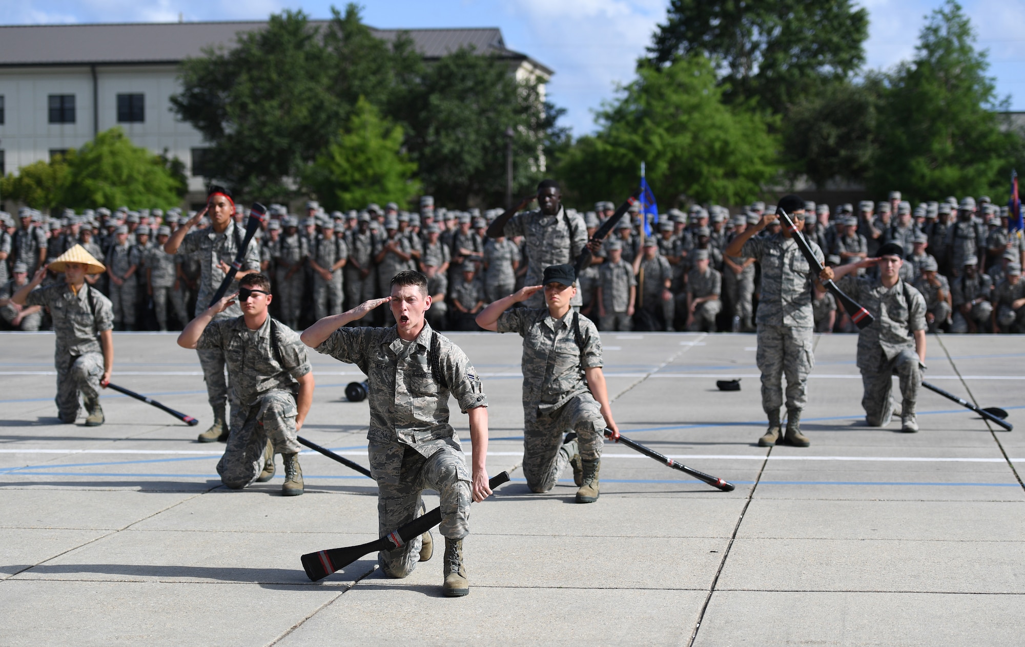The Keesler Air Force Base freestyle drill team performs their routine at the Levitow Training Support Facility drill pad on Keesler Air Force Base, Mississippi, May 21, 2019. The drill teams, made up of Airmen from various squadrons within the 81st Training Group, debuted their performances in front of base leadership and their peers. Every year both the regulation and freestyle teams compete at Lackland Air Force Base, Texas, for "Best Technical Training Drill Team of the Year." However, this year it was cancelled due to inclement weather. (U.S. Air Force photo by Kemberly Groue)