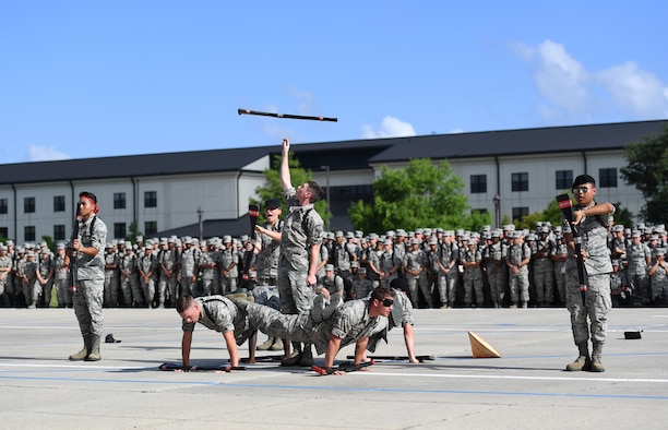 The Keesler Air Force Base freestyle drill team performs their routine at the Levitow Training Support Facility drill pad on Keesler Air Force Base, Mississippi, May 21, 2019. The drill teams, made up of Airmen from various squadrons within the 81st Training Group, debuted their performances in front of base leadership and their peers. Every year both the regulation and freestyle teams compete at Lackland Air Force Base, Texas, for "Best Technical Training Drill Team of the Year." However, this year it was cancelled due to inclement weather. (U.S. Air Force photo by Kemberly Groue)