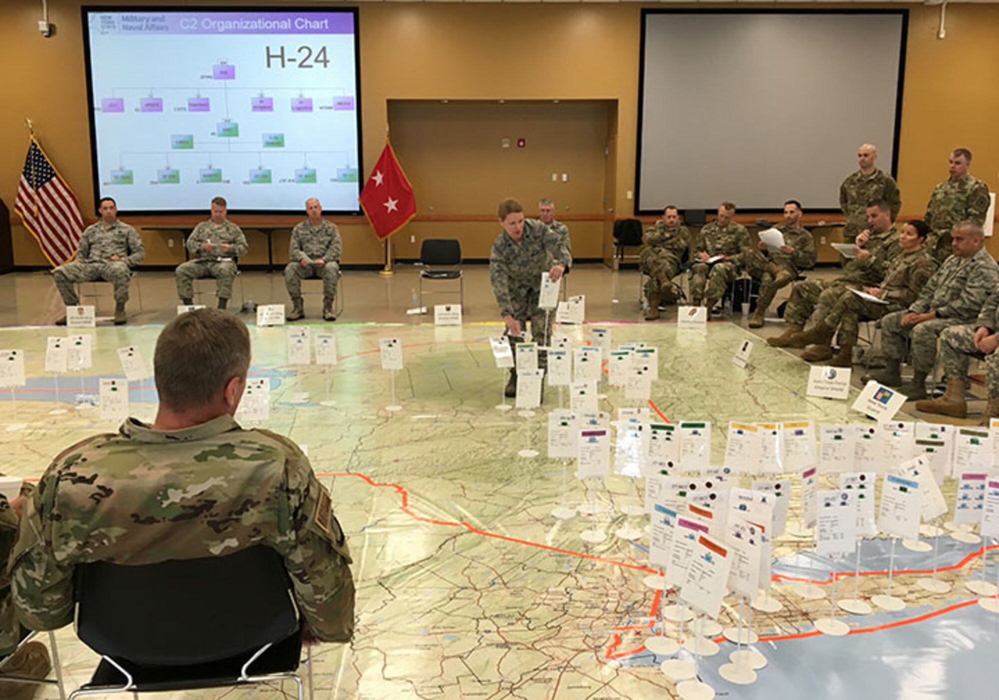 New York Air National Guard Lt. Col. Tammy Street, center, commander of the logistics readiness squadron of the 109th Airlift Wing, moves a placard representation of a wing response element during the rehearsal of New York military forces plan for a coastal storm during the 2019 hurricane season at the Armed Forces Reserve Center in New Windsor, N.Y., May 23, 2019.