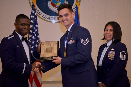 Col. Terrence Adams, 628th Air Base Wing commander, left, and Master Sgt. Calantha Pickel, Airman Leadership School commandant, right, present Staff Sgt. Ryan Erb, 437th Aircraft Maintenance Squadron, a plaque for earning the John L. Levitow Award during the Airman Leadership School Graduation ceremony May 23, 2019, at Joint Base Charleston. The Levitow Award is the highest honor awarded to an ALS graduate and is given to the Airman who displays the highest level of leadership qualities during the course. ALS is a five-week course encompassing lessons in the principles of supervision and management, the importance of communication and military professionalism.