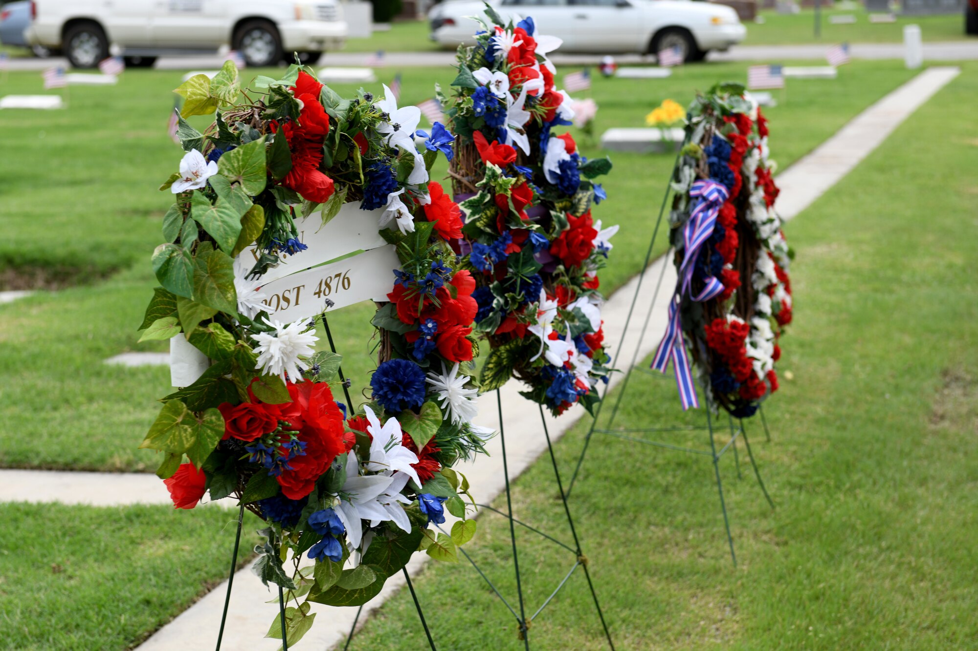 Wreaths are displayed for a crowd on Memorial Day, May 27, 2019, at Altus, Okla. Each year, members from the 97th Air Mobility Wing gather at the Altus City Cemetery and pay their respects to those who served before them.