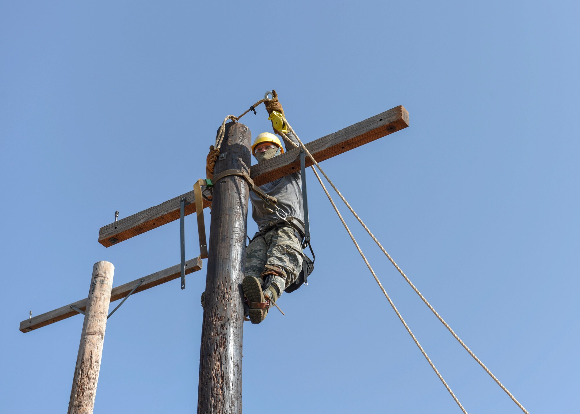 A 366th Training Squadron electrical apprentice course student climbs an electrical pole at Sheppard Air Force Base, Texas, May 28, 2019. One of the training students must accomplish is learning to trust their gear. One of their equipment includes the super squeeze belts, which allows the climber to perform their duties with confidence without worrying of the danger of injuries due to falling. (U.S. Air Force photo by Senior Airman Ilyana A. Escalona)