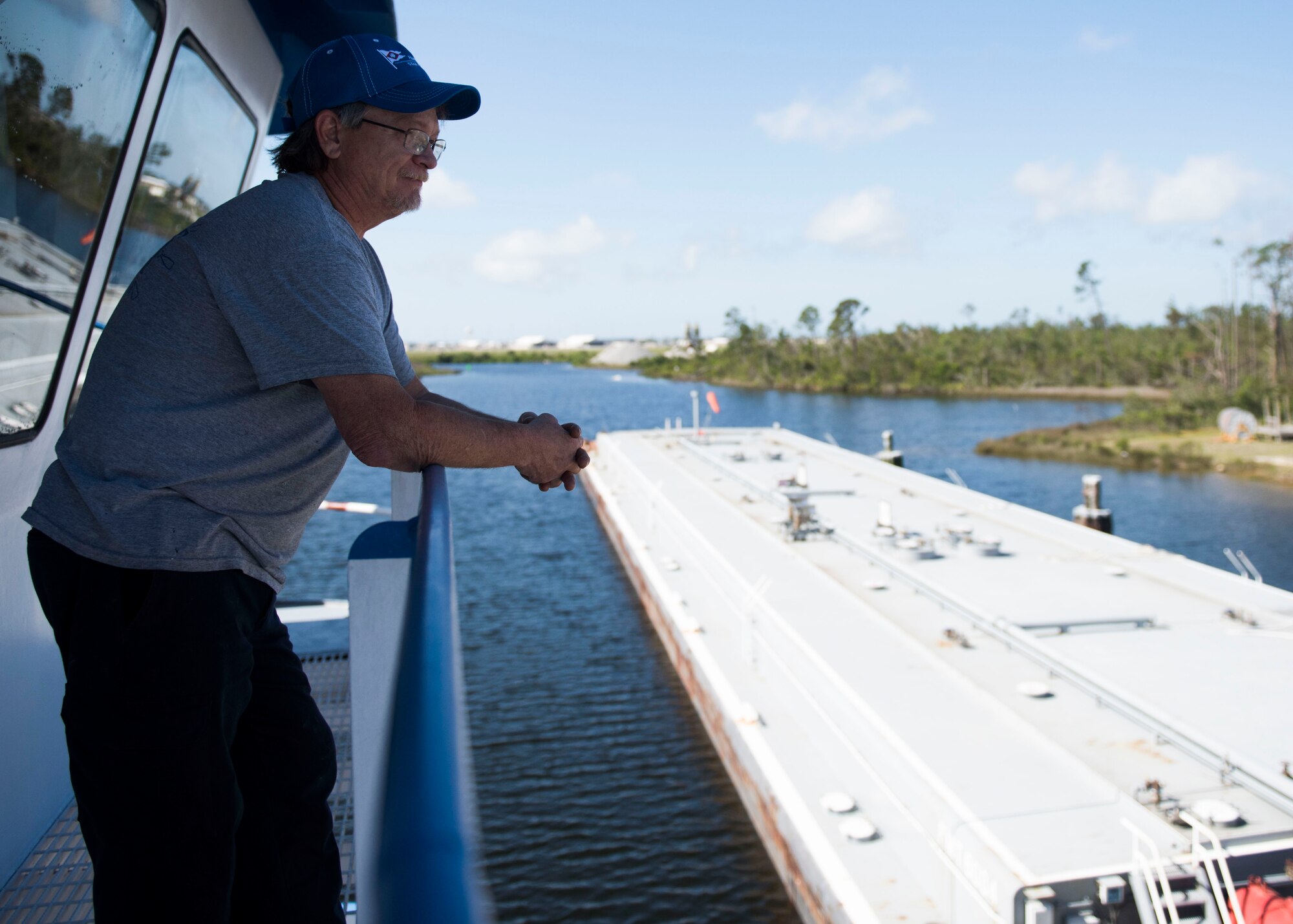 Ricky Boudreaux, captain of the Rhonda Lamulle looks over at a fuel barge May 21, 2019, at Tyndall Air Force Base, Florida.