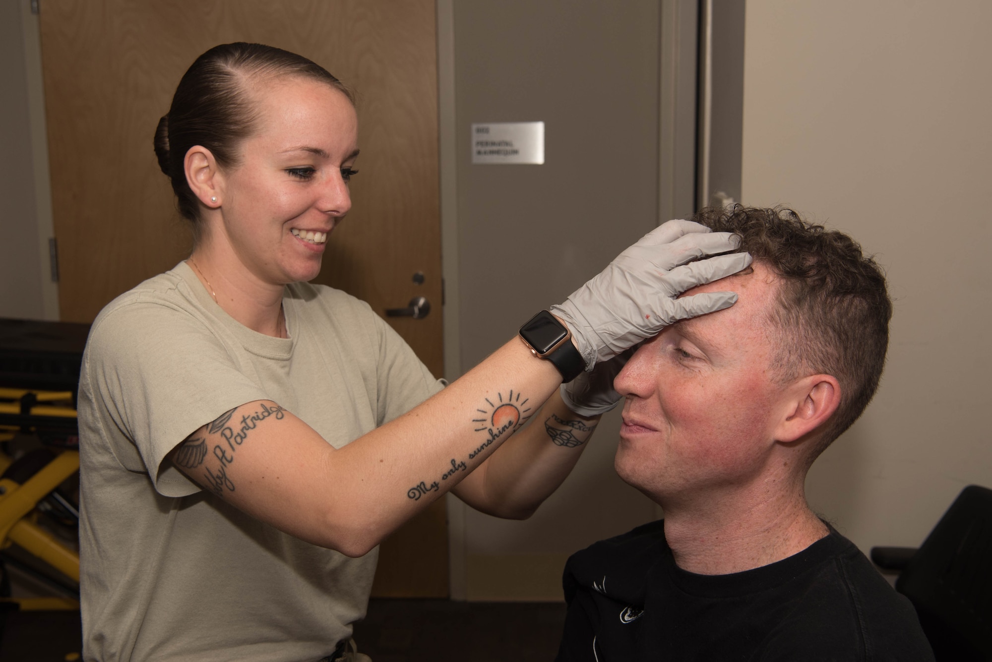 U.S. Air Force Staff Sgt. Sierra Jones, 633d Impatient Operations Squadron medical technician, applies makeup to volunteer Senior Airman Charles Schwarz, 36th Intelligence Squadron geospatial intelligence analyst, on Joint Base Langley-Eustis, Virginia, May 17, 2019. Jones was just one member who was tasked with applying makeup to volunteers to simulate real life injuries. (U.S. Air Force photo by Airman 1st Class Marcus M. Bullock)
